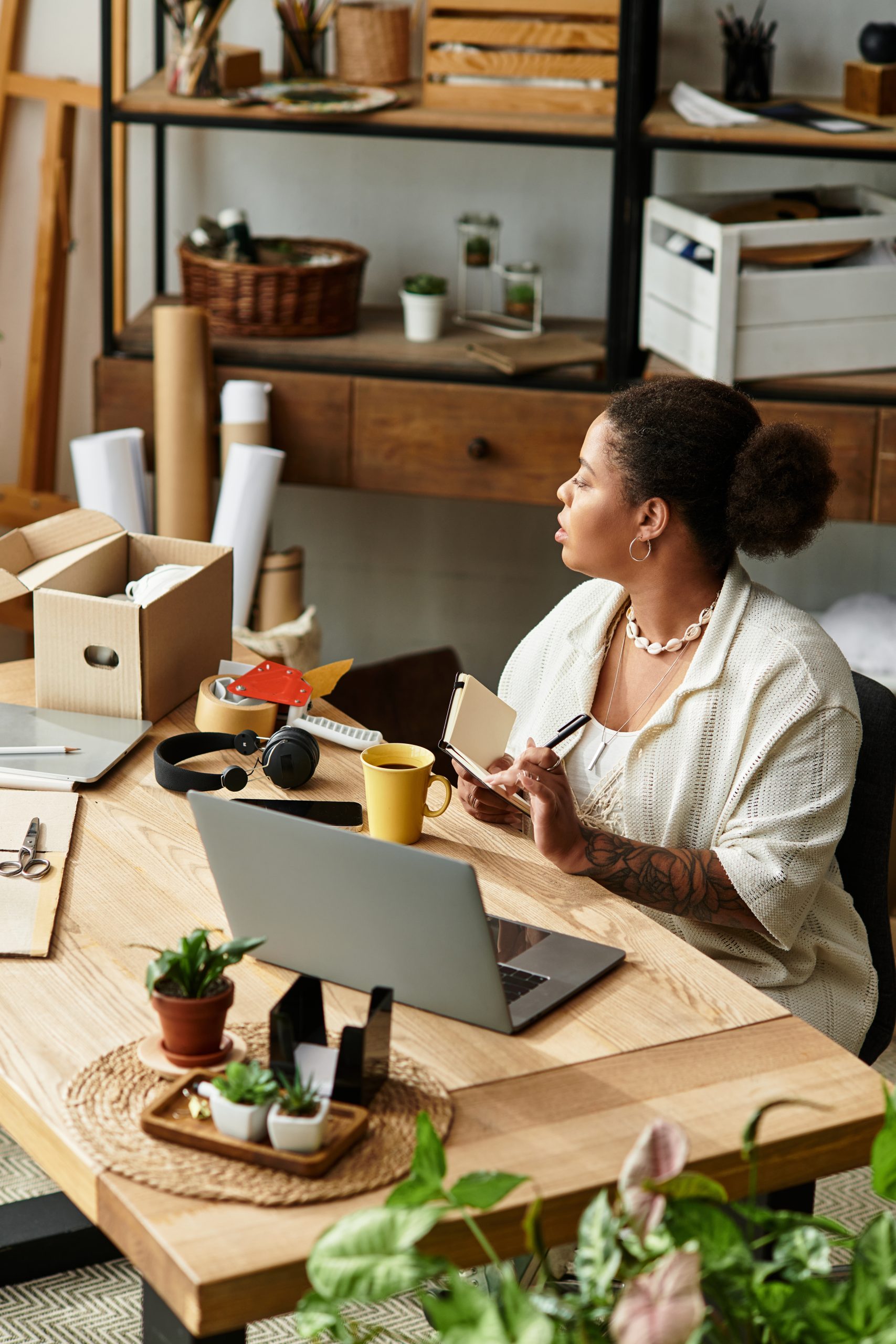 A beautiful woman engages in crafting, surrounded by materials and a cozy workshop atmosphere.