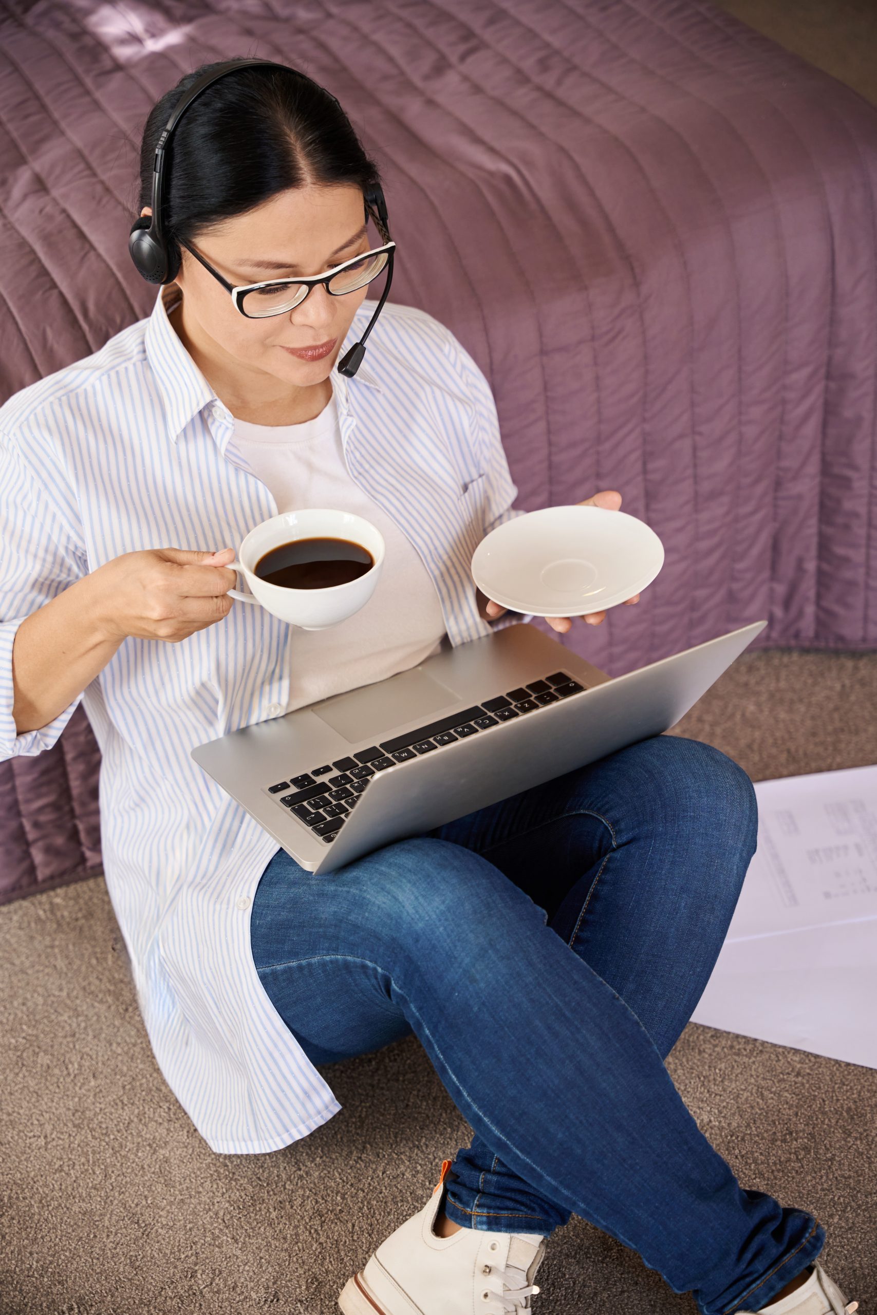 Focused female freelancer is using her laptop indoors